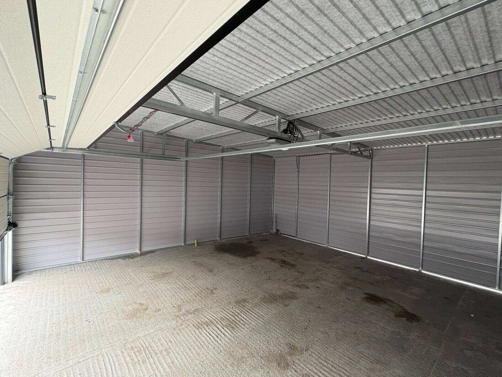 Anthracite steel garage on a prepared base, side elevation