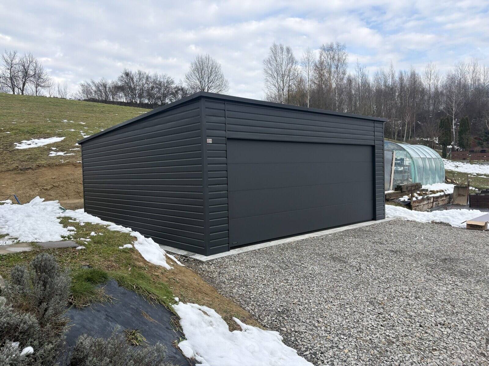 Anthracite steel double garage on a gravel base, sectional door closed