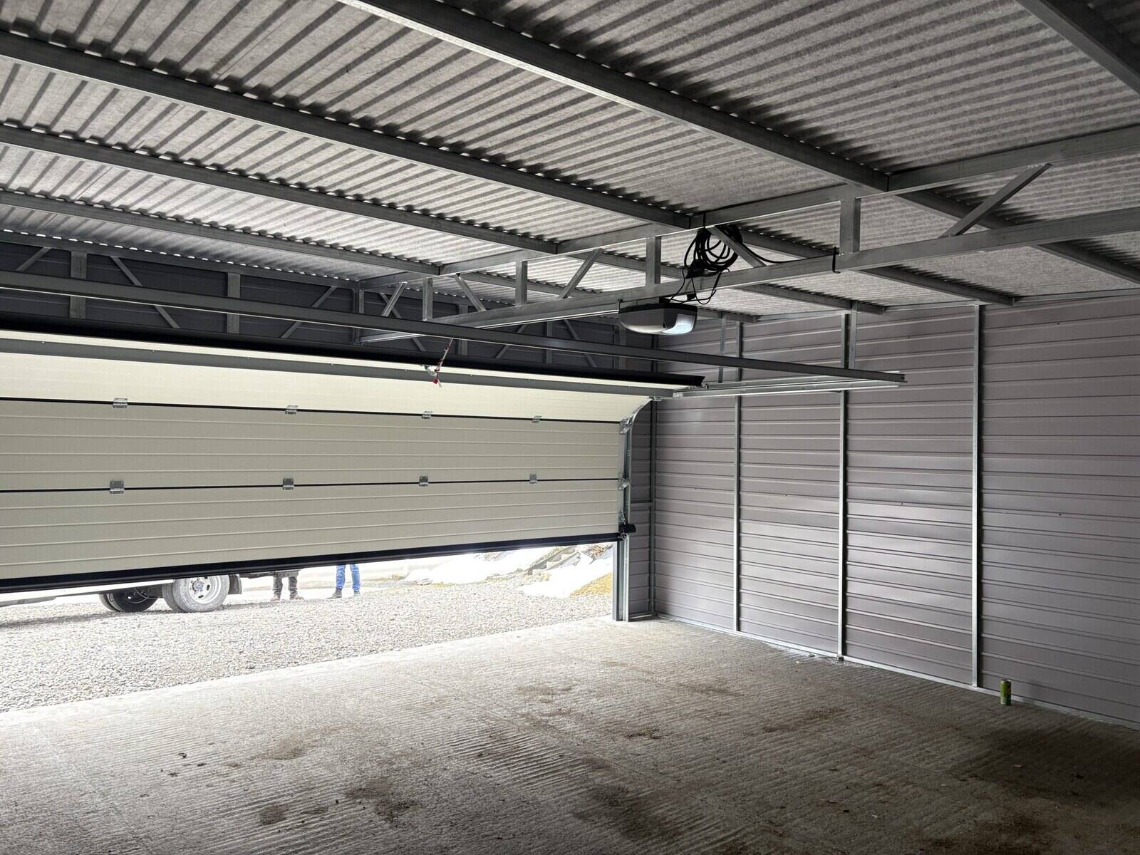 Inside a finished steel garage with a full-width sectional door